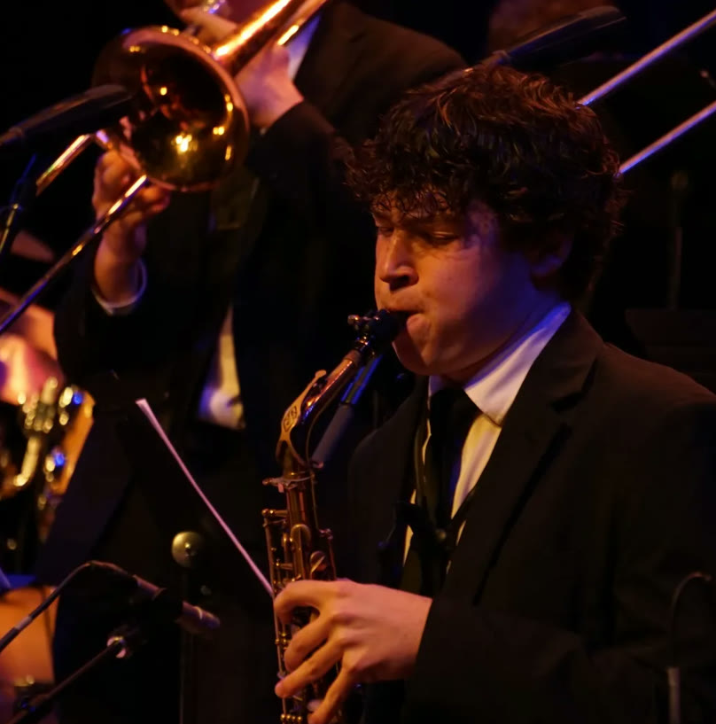 Liam Jakubowski performing saxophone on stage