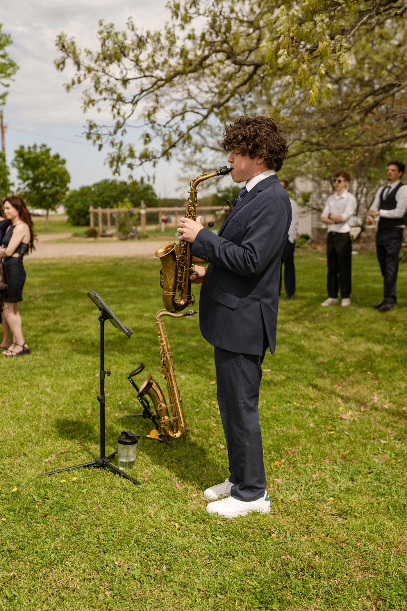 Liam Jakubowski playing saxophone at an outdoor wedding
